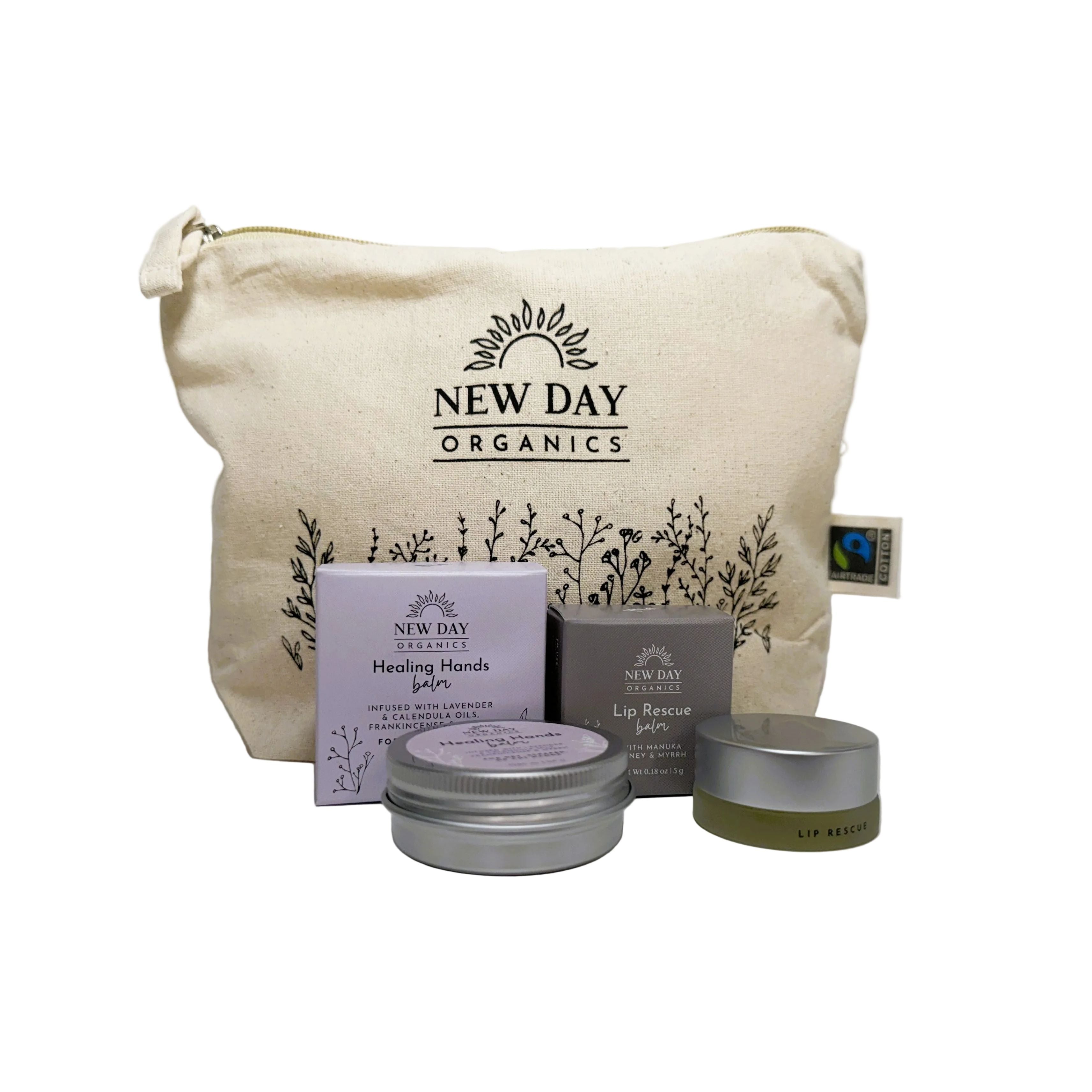 New Day Organics skincare products including a pouch, boxes, and tins on a white background