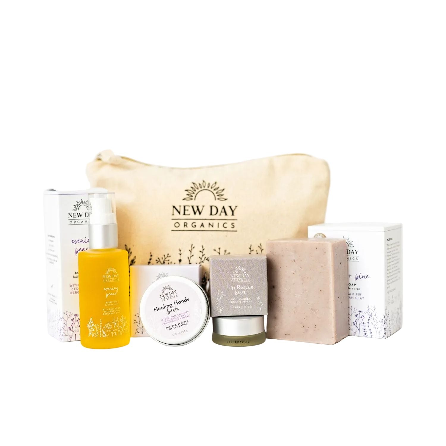 Collection of New Day Organics skincare products including a bag, bottle, and bars on a white background.