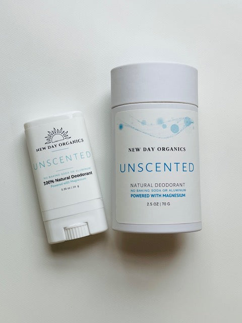 Two New Day Organics unscented natural deodorants on a light background