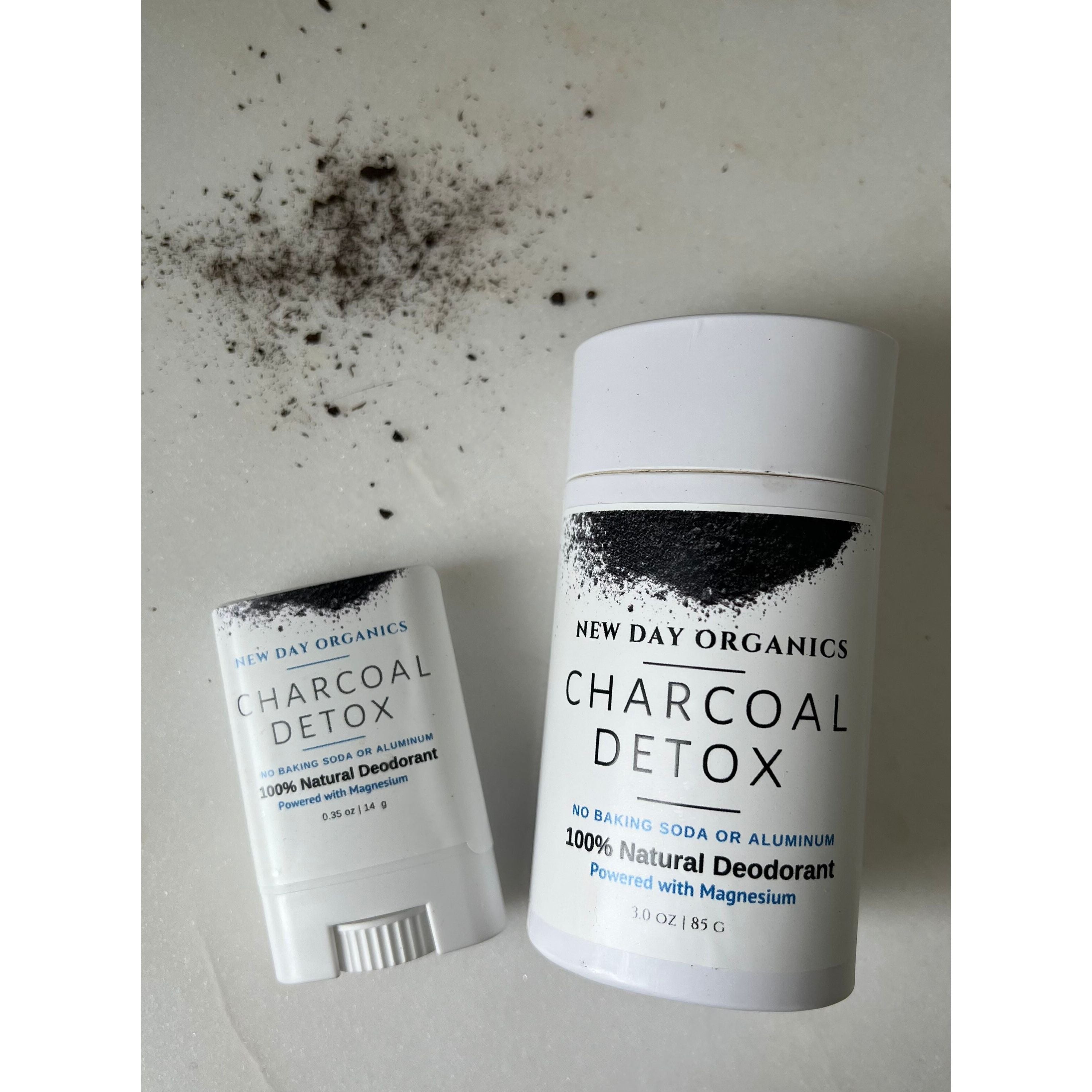 New Day Organics Charcoal Detox deodorant stick and container on a light background