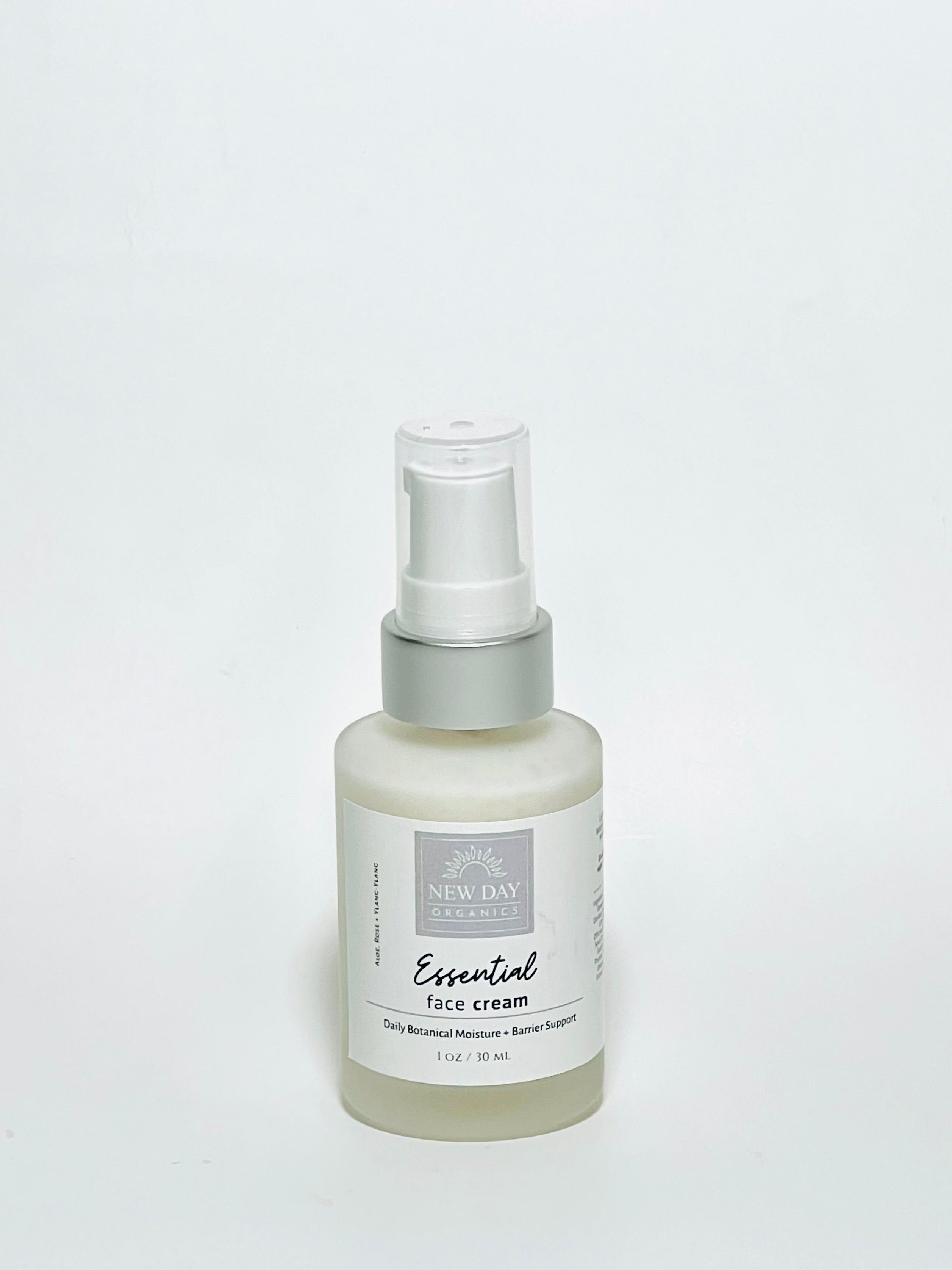 Bottle of essential face cream on a white background