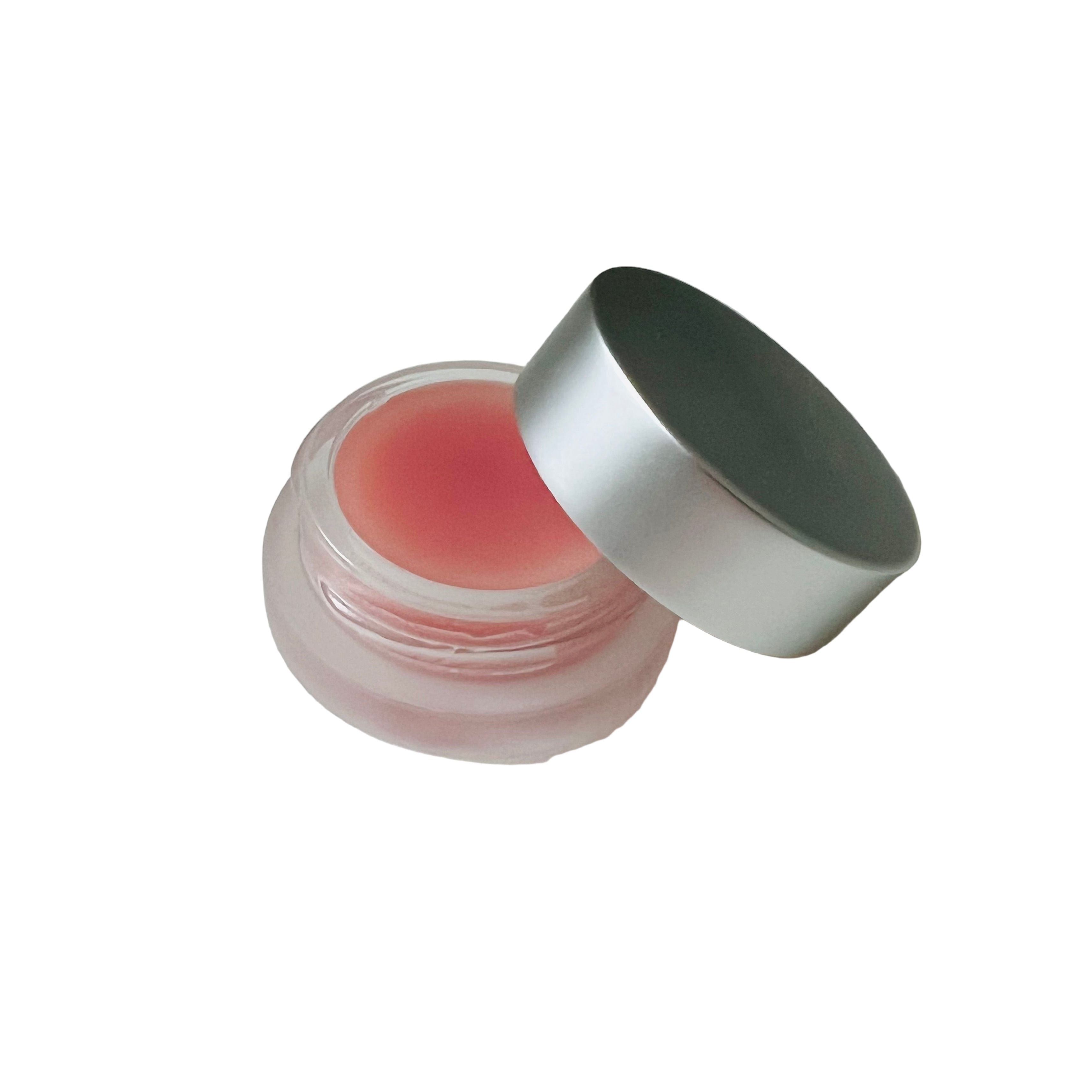 Lip balm container with a silver lid on a white background