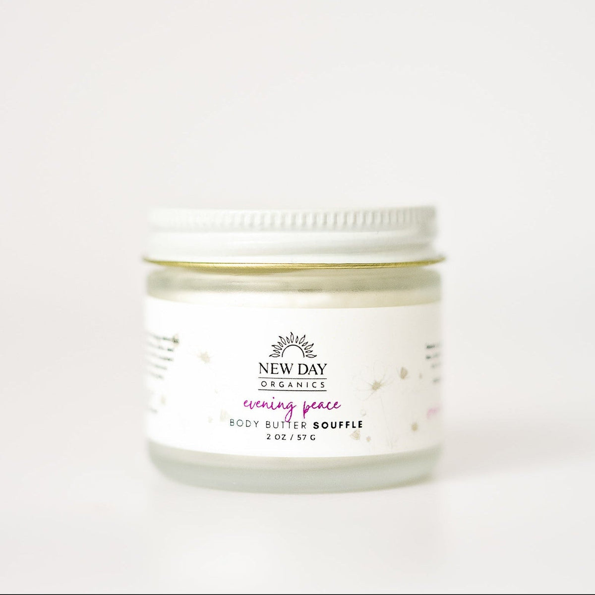 Jar of New Day Beauty body butter on a white background