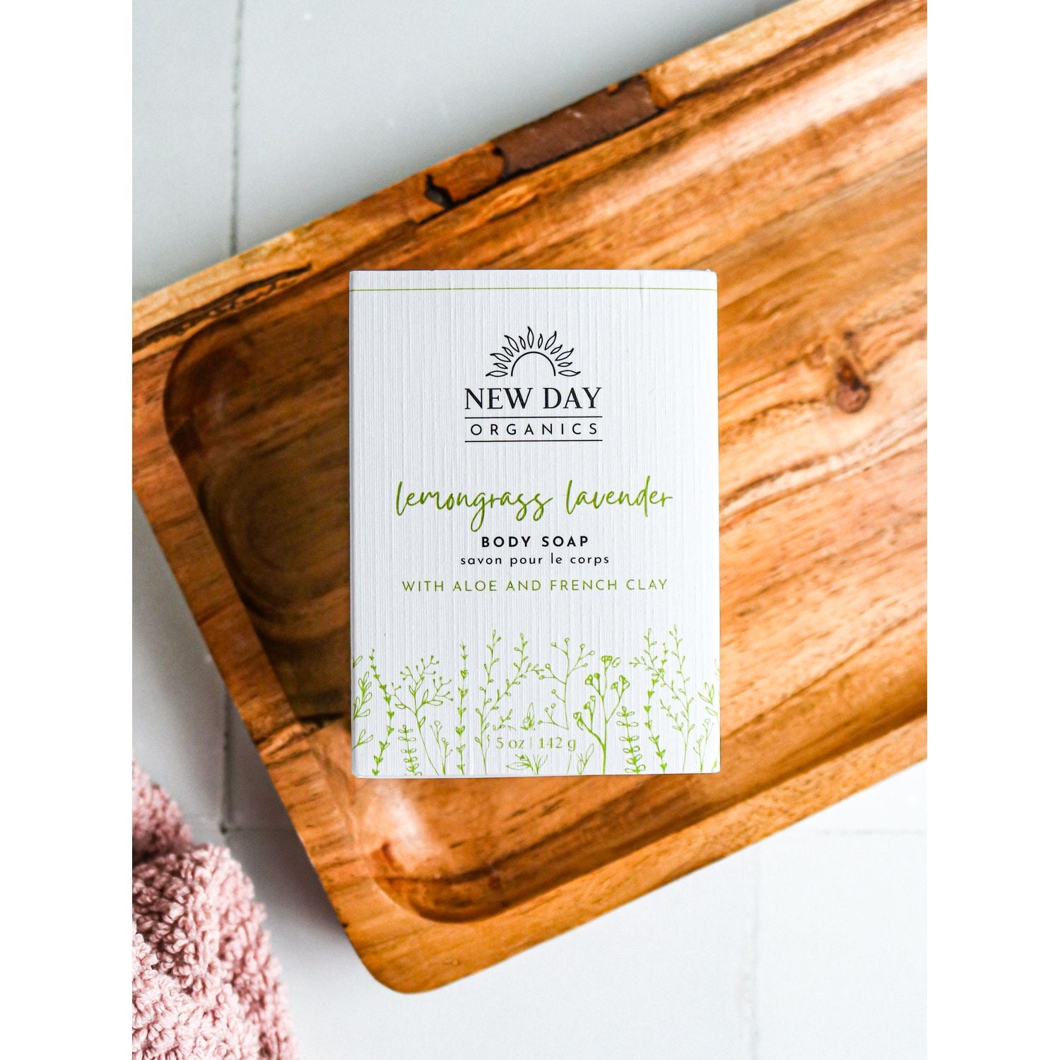 New Day Organics lemongrass lavender body soap on a wooden tray with a white background