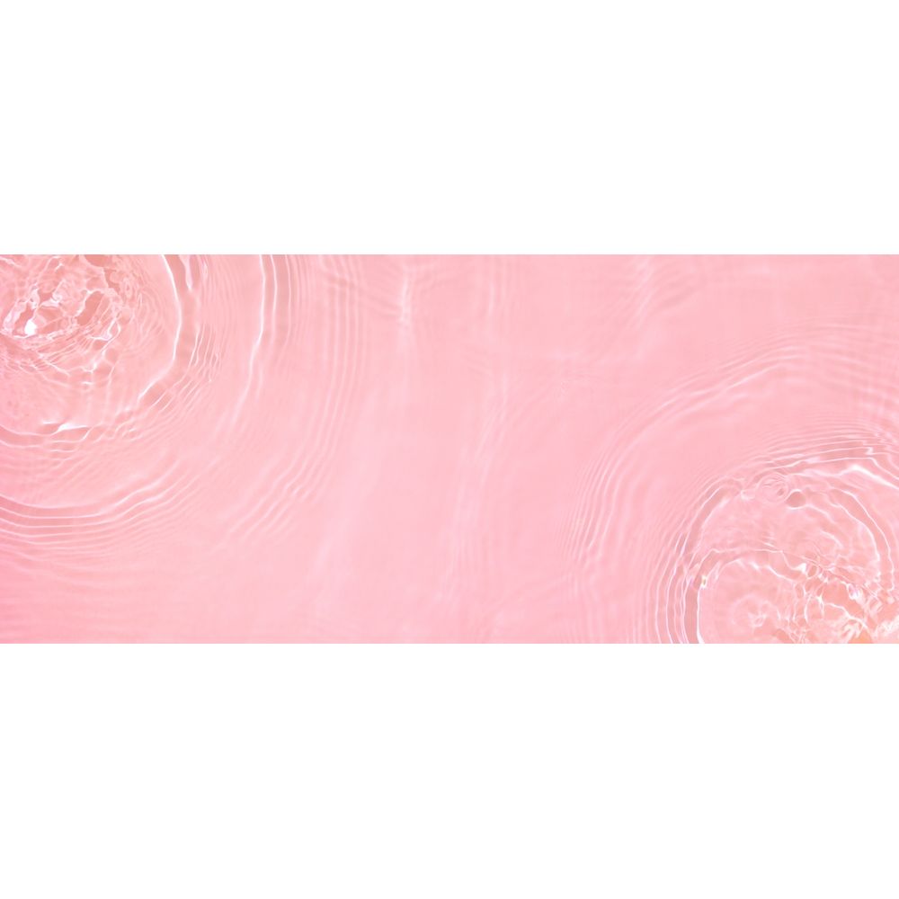 Pink surface with circular patterns and water droplets